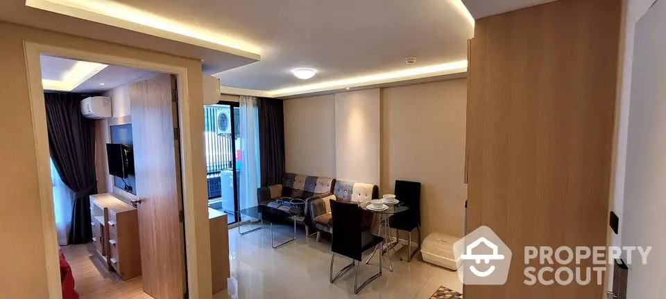 Modern living room with sleek furniture and ambient lighting in a stylish apartment.