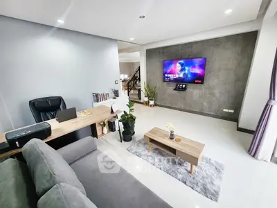 Modern living room with sleek furniture and wall-mounted TV