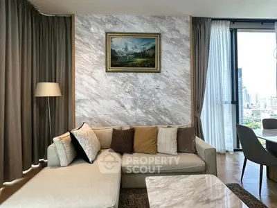 Luxurious living room with elegant decor and city view, featuring a cozy sofa and stylish marble accents.