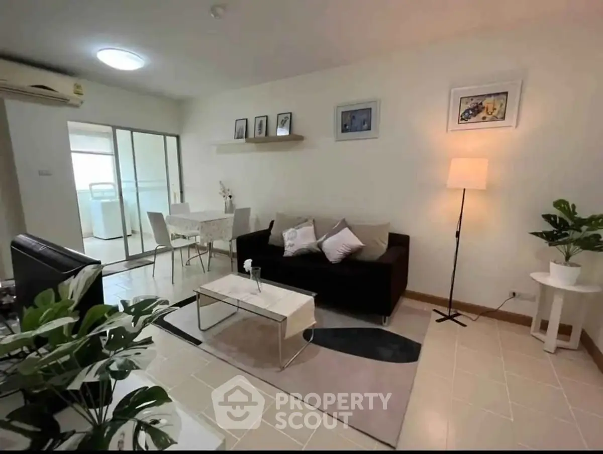 Modern living room with stylish decor and dining area in open layout apartment.