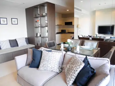Modern living room with stylish decor and open kitchen layout in a contemporary apartment.