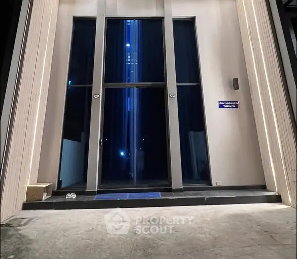 Modern building entrance with sleek design and ambient lighting