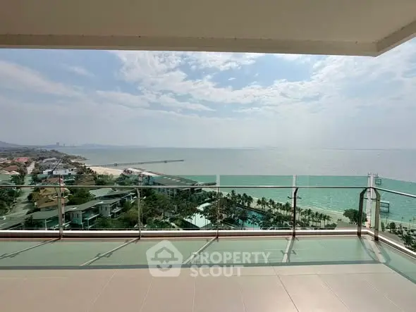 Stunning ocean view from spacious balcony in luxury beachfront property.