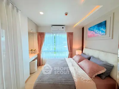 Luxurious bedroom with elegant decor and large window offering natural light