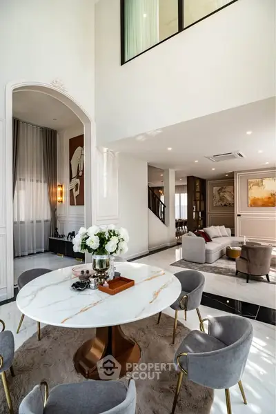 Luxurious modern living room with elegant dining area and high ceilings