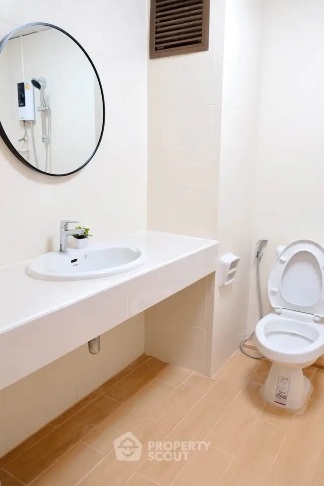 Modern bathroom with sleek fixtures and wooden flooring