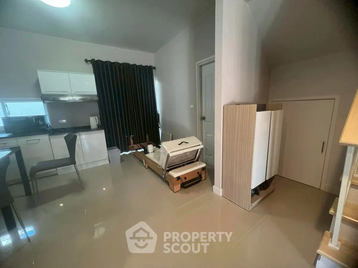 Modern living room with sleek kitchen and stylish furniture in open layout