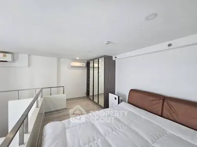 Modern loft bedroom with sleek design and ample natural light