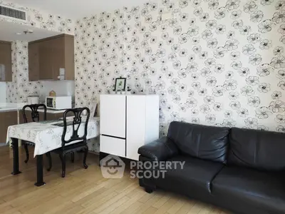 Charming living room with floral wallpaper and modern furniture in cozy apartment.