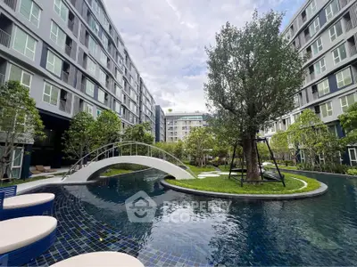 Stunning residential complex with serene pool and lush greenery, perfect for modern living.