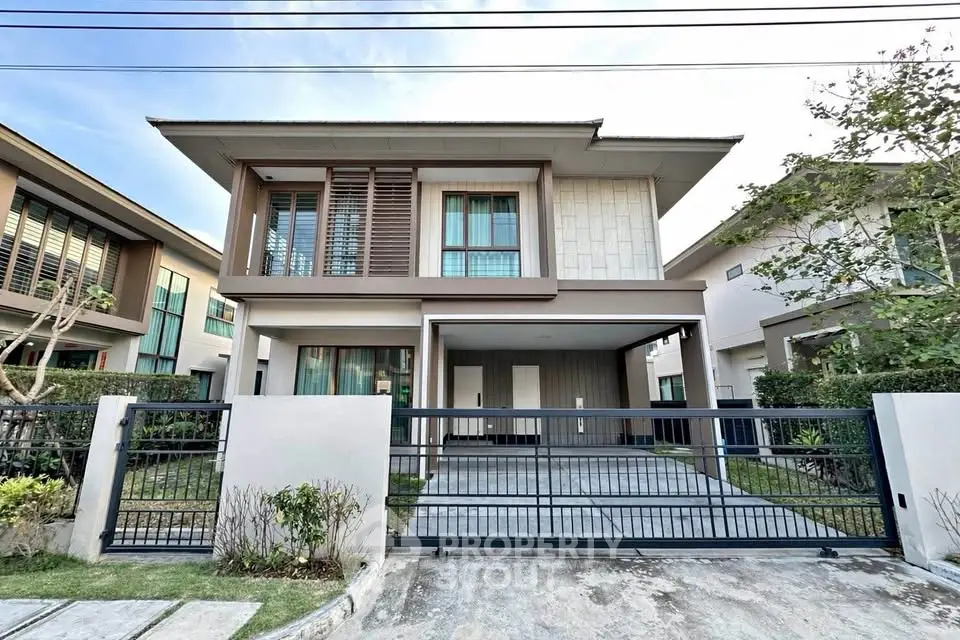 Modern two-story house with sleek design and spacious driveway in a serene neighborhood.