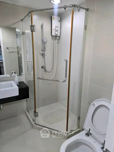 Modern bathroom with glass shower enclosure and sleek fixtures