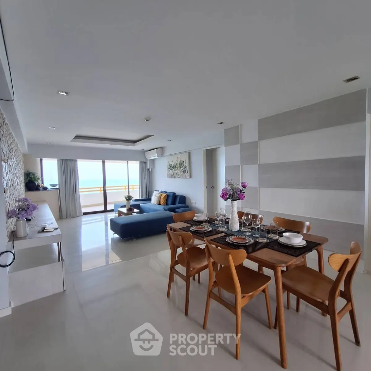Spacious modern living room with ocean view and elegant dining area