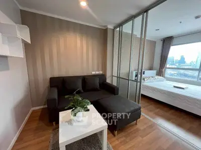 Modern living room with cozy sofa and adjacent bedroom featuring city view.