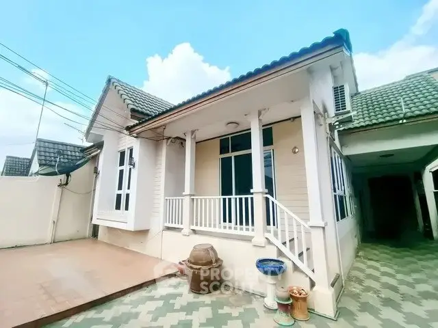 Charming single-story house with classic architecture and spacious front porch.