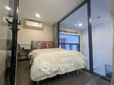 Modern bedroom with glass wall and cozy decor in a stylish apartment