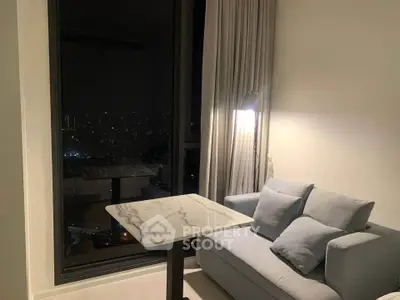 Cozy living room with city view, featuring a modern sofa and elegant marble table.