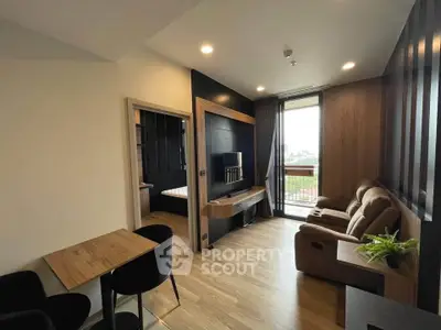 Modern living room with wooden flooring and balcony view in a stylish apartment