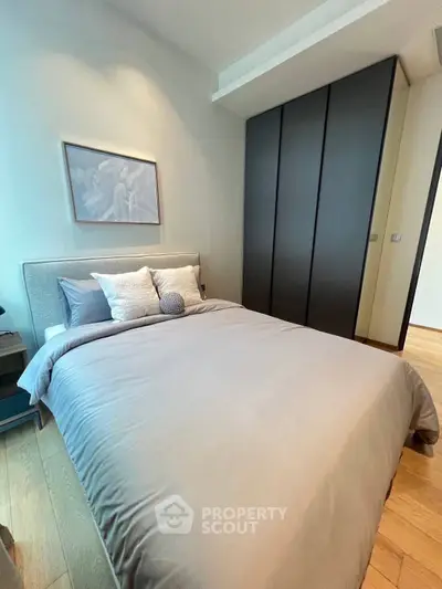 Modern bedroom with sleek design and ample storage in a stylish apartment.