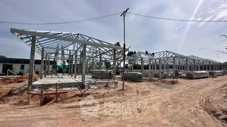 Modern construction site with steel frame structures under clear sky