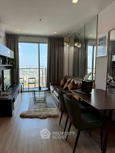 Stylish modern living room with city view, elegant decor, and cozy seating area.