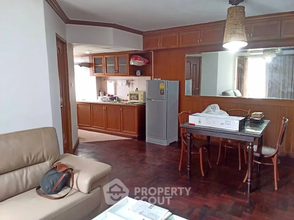Spacious living room with open kitchen and dining area in cozy apartment