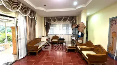 Spacious living room with elegant drapery and classic wooden furniture, perfect for family gatherings.