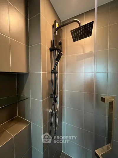 Modern bathroom shower with sleek black fixtures and tiled walls