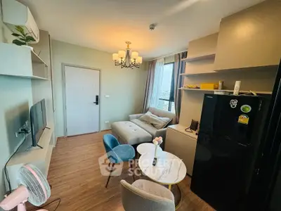 Cozy living room with modern decor and natural light, featuring a comfortable sofa and stylish chandelier.