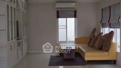 Spacious living room with modern furniture and air conditioning