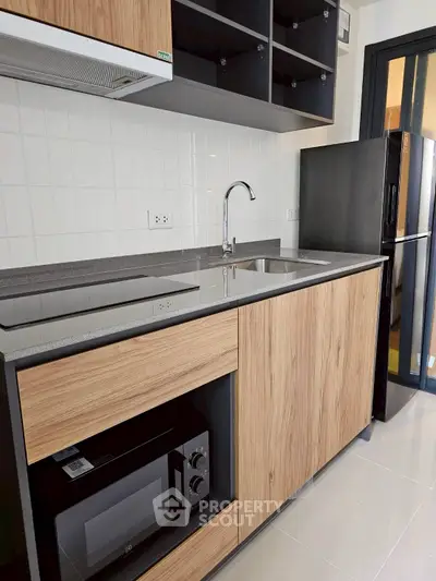 Modern kitchen with sleek wooden cabinets and built-in appliances