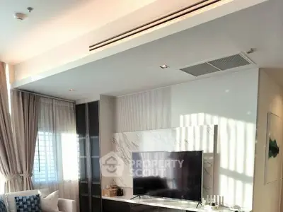 Modern living room with sleek TV setup and elegant curtains