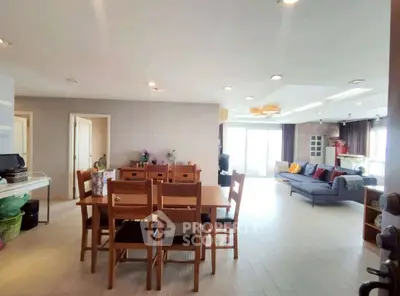 Spacious open-plan living and dining area with modern furnishings and ample natural light.
