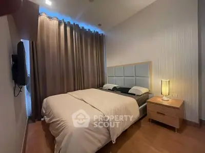 Cozy bedroom with modern decor and soft lighting, perfect for relaxation.