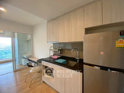 Modern kitchen with sleek cabinets and balcony view