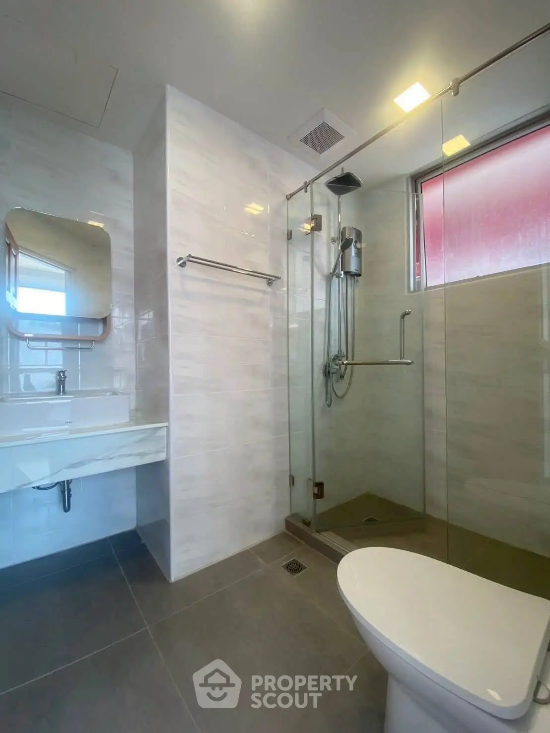 Modern bathroom with glass shower and sleek fixtures