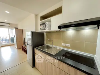 Modern kitchen with sleek appliances and open layout in a bright apartment.