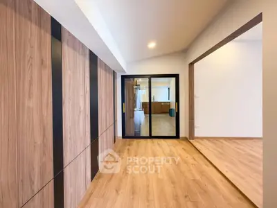 Spacious modern interior with wooden flooring and sliding glass doors