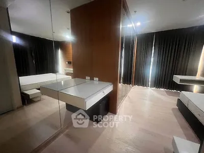 Modern bedroom with mirrored wall and sleek design