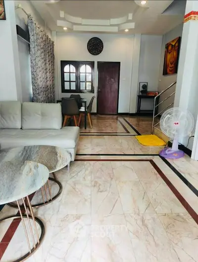 Spacious living room with elegant marble flooring and modern decor