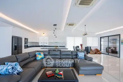 Luxurious open-plan living room with modern kitchen and stylish decor