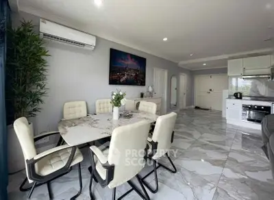 Spacious modern dining area with marble flooring and open kitchen layout