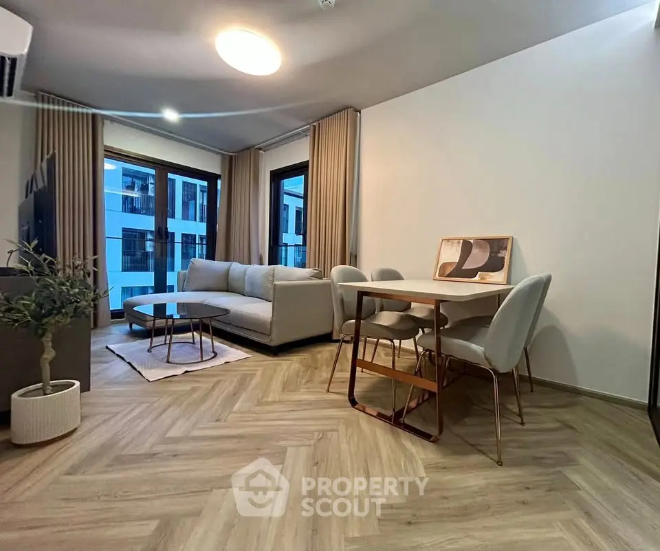 Modern living room with stylish furniture and large windows in a contemporary apartment.