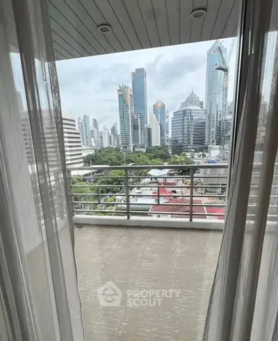 Stunning cityscape view from a modern balcony in a high-rise apartment.