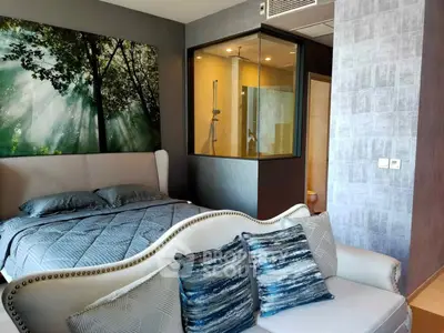 Luxurious bedroom with modern decor and unique glass shower feature