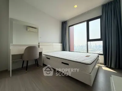 Modern bedroom with city view, featuring a sleek design and ample natural light.