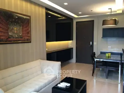 Modern living room with elegant decor and dining area in a stylish apartment.