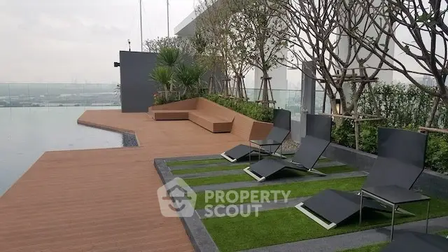 Luxurious rooftop pool area with modern lounge chairs and stunning city views.