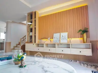 Modern living room with stylish wooden paneling and elegant decor