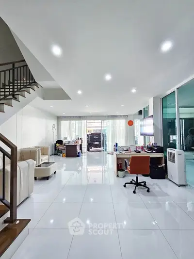Spacious modern living room with sleek white tiles and contemporary furniture